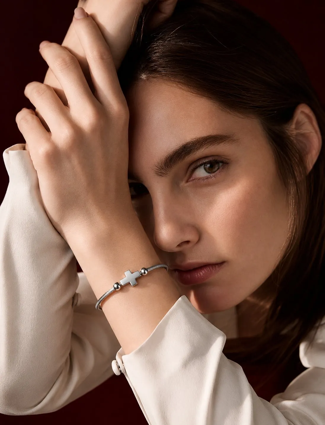 Close-up of a woman wearing the cross bracelet